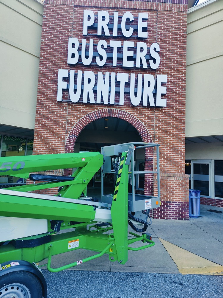 Lift truck servicing a storefront sign